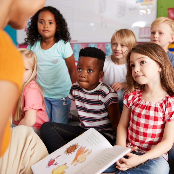 group of students listening to teacher read