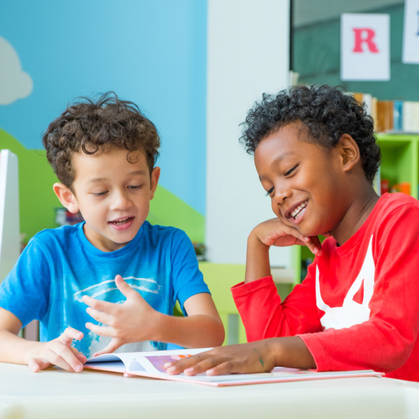 two boys reading book